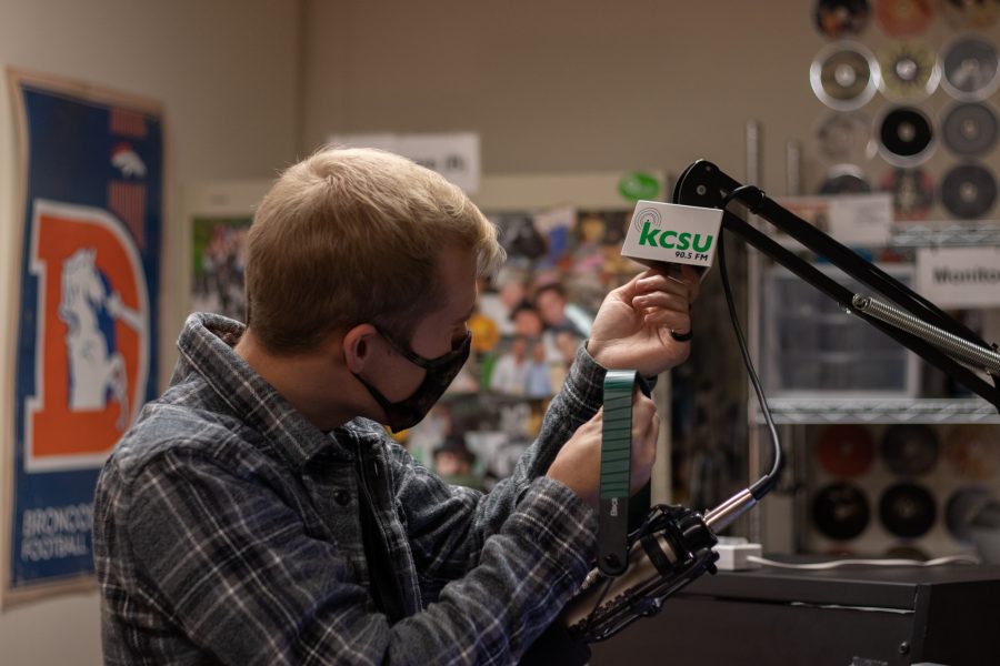 Ben Haney, assistant podcast director at Colorado State University, at his desk setting up a mic behind the DJ Booth under Lory Student Center Oct 11. Haney stated, “Something about podcasting really drew me in so in the future I really want to work in podcasting or in audio format.” (The Collegian | Grayson Reed)