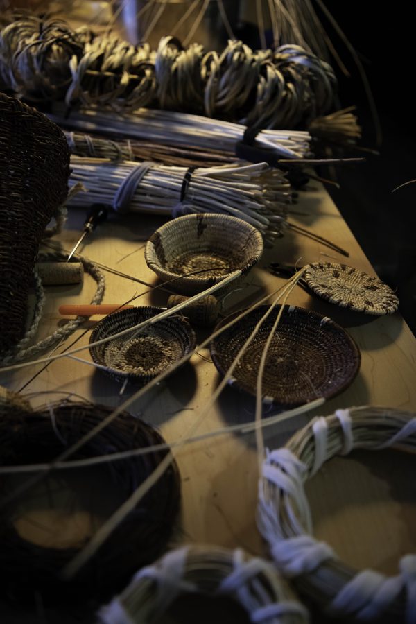 Traditional hand-woven baskets and material sit on Stephen Young’s kitchen table Oct. 12. Young is the first in five or more generations of his family to weave basketry, learning for the past two years from tribal masters as well as on his own. (Garrett Mogel | The Collegian)