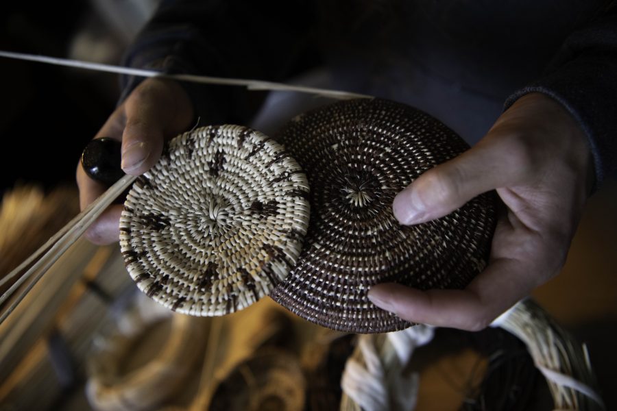 Stephen Young holds the beginnings of a hand-woven basket and tray in his Colorado State University campus apartment Oct. 12. The baskets are coiled to the left, a tradition of Northern California tribes, and are made from California redbud. Young is the first in five or more generations of his family to weave basketry, learning for the past two years from tribal masters as well as on his own. (Garrett Mogel | The Collegian)