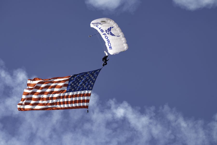 A United States Air Force Wings of Blue member parachutes into the opening ceremony of the Great Colorado Air Show at the Northern Colorado Regional Airport in Loveland, Colorado, presenting the American flag Oct. 17. (Garrett Mogel | The Collegian)