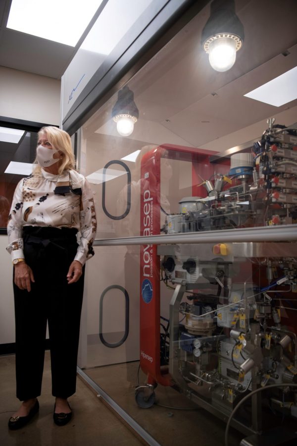 Leslie Buttorff, Chief Executive Officer of Panacea Life Sciences stands in the new Cannabinoid Research Center in the Colorado State University Yates Chemistry building next to a chromatography machine referred to as the Novasep. Buttorff donated 1.5 million dollars to CSU to build the lab and further cannabinoid research. Buttorff stated, “What we want to do is find unique cannabinoids that can help people, natural remedies to get rid of big pharma medicine that people have.” Oct. 19. (Garrett Mogel | The Collegian)