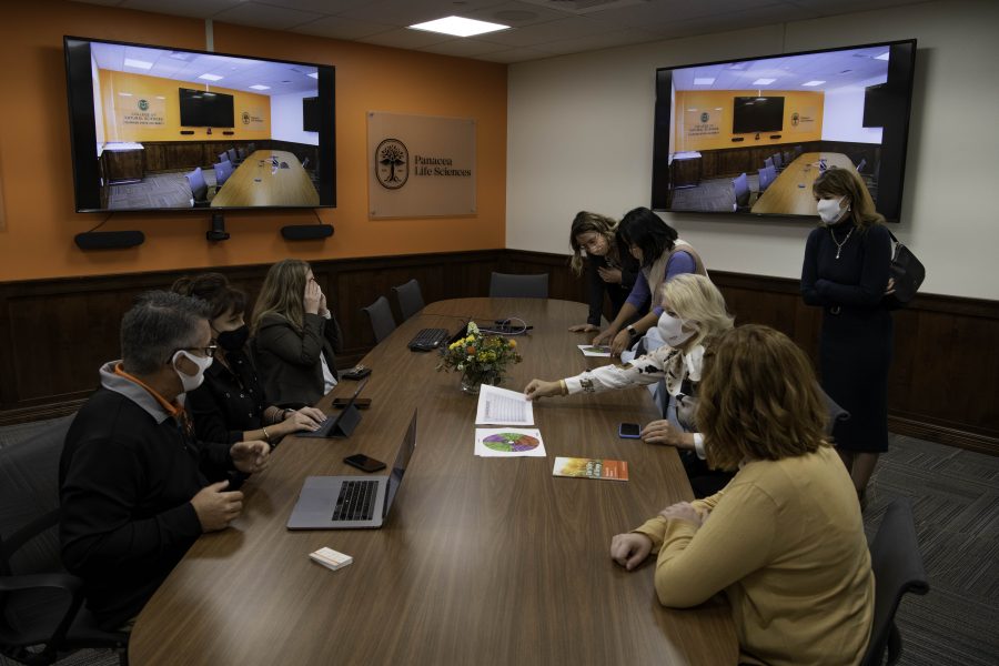 Members of the new Cannabinoid Research Center in the Colorado State University Yates Chemistry building discuss the new lab in the accompanying board room. The lab was a 1.5-million-dollar gift from CSU alumna Leslie Buttorff, Chief Executive Officer of Panacea Life Sciences. Buttorff stated, “If you look at the one thing about cannabis it needs a lot more research. And this lab is perfect for that.” Oct. 19. (Garrett Mogel | The Collegian)