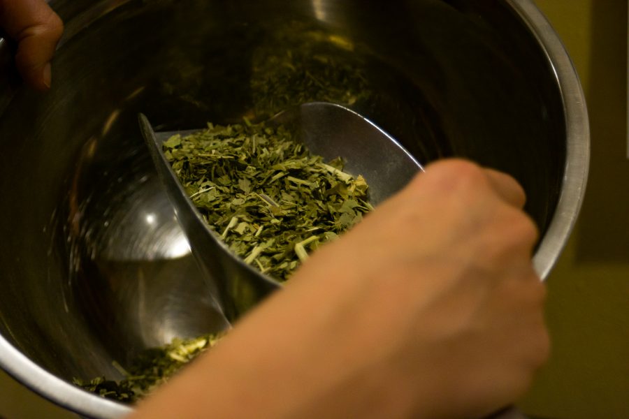 Sarah Josey measures out Passion Flower for a tincture