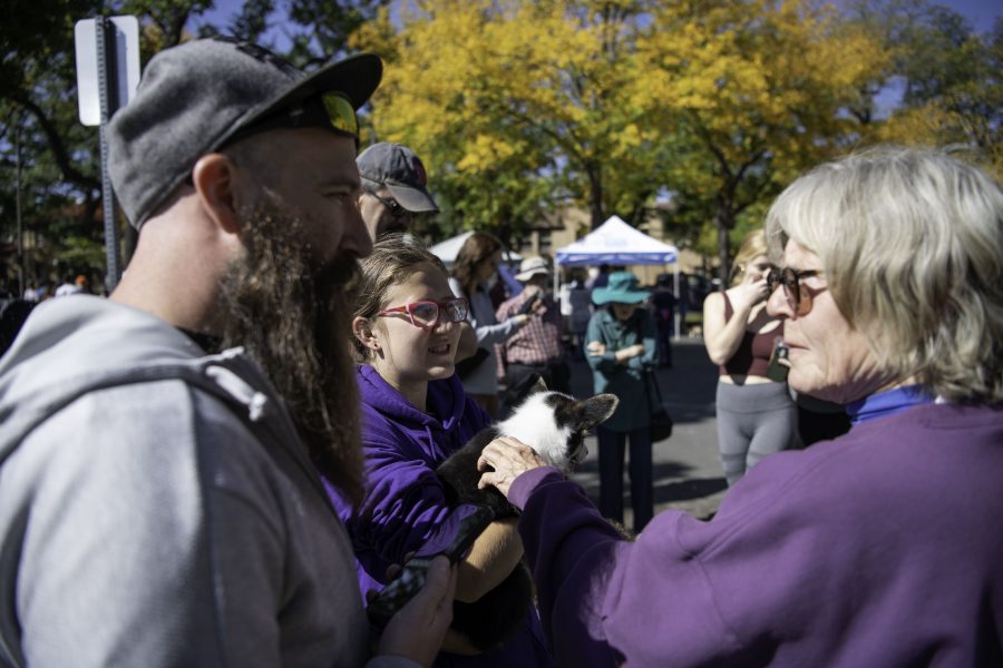 Ben (Right) and Iakoda Meyers (Center) adopt a Corgi puppy from Bear Creek Corgis while at Tour De Corgi stating, “It’s always been our dream to get a female corgi.” Tour De Corgi took place at the Civic Center Park in Fort Collins Colorado Oct. 2. (Garrett Mogel | The Collegian)