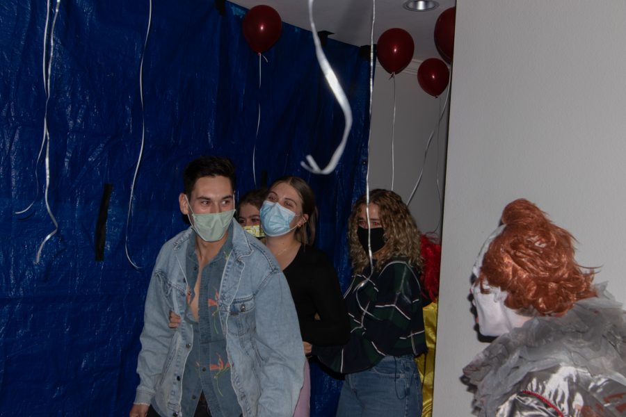 Flash photo of participants being jump scared at the Theta Chi fraternity haunted house at The Outpost Leasing Center at 530 Lupine Drive, Fort Collins Oct 22. The Colorado State University fraternity hosted the yearly haunted house to sponsor a fundraiser for the United Service Organizations as their roots were based from military students, 100% of the proceedings went to the USO. (Grayson Reed | The Collegian)