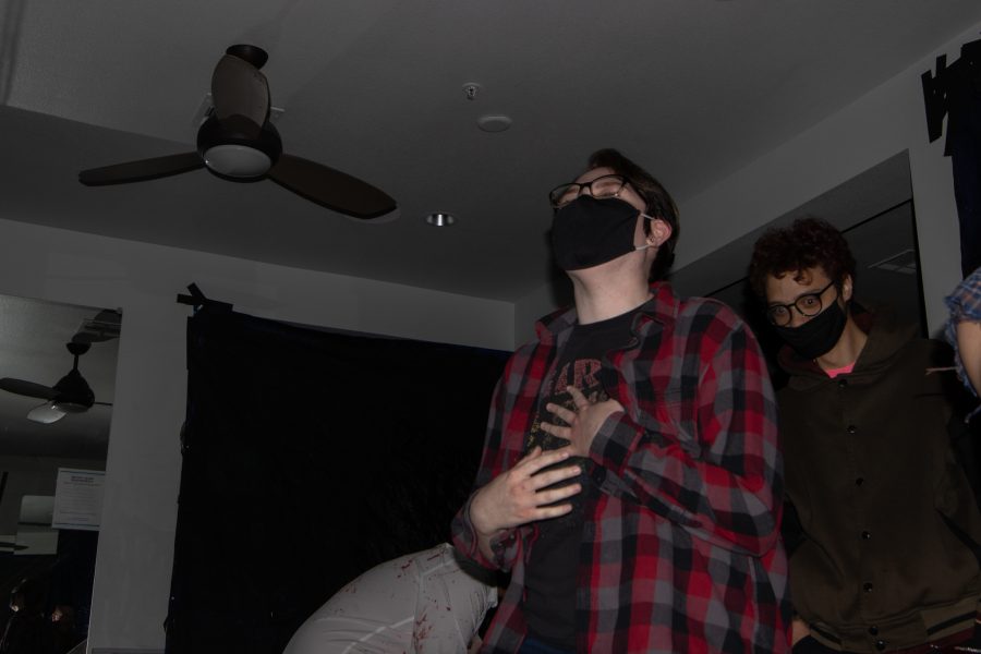 Flash photo of Zee, Tyler Ellis and CJ Korn being jump scared at the Theta Chi fraternity haunted house at The Outpost Leasing Center at 530 Lupine Drive, Fort Collins Oct 22. CJ commented afterwards, “I thought it was really well put together, you could tell they have definitely spent time making everything perfect.” The Colorado State University fraternity hosted the yearly haunted house to sponsor a fundraiser for the United Service Organizations as their roots were based from military students, 100% of the proceedings went to the USO. (Grayson Reed | The Collegian)