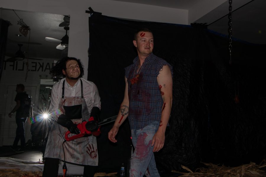 Flash photo of Erik Danielson, Vice President of Theta Chi being audibly attacked by Bronson Torres while doing a walk through before real participants went through the haunted house at The Outpost Leasing Center at 530 Lupine Drive, Fort Collins Oct 22. The Colorado State University fraternity hosted the yearly haunted house to sponsor a fundraiser for the United Service Organizations as their roots were based from military students, 100% of the proceedings went to the USO. (Grayson Reed | The Collegian)