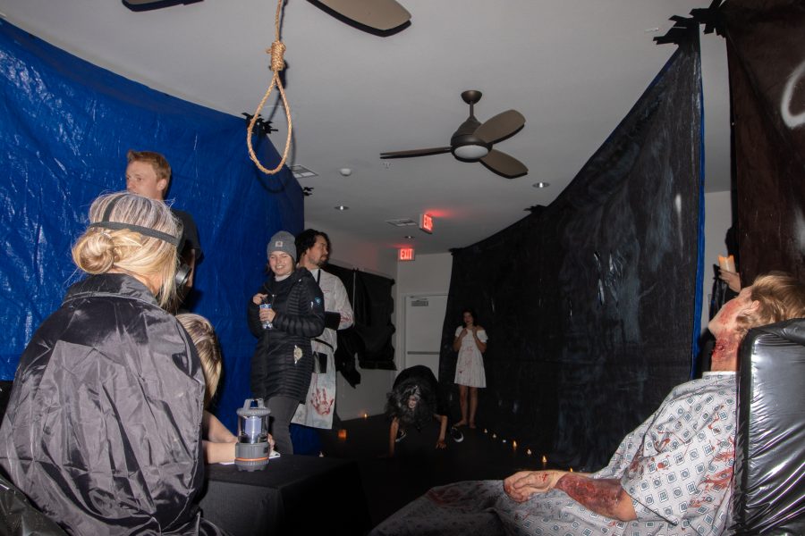 Flash photo of organizers of the Theta Chi fraternity haunted house being chased during a pre-open walkthrough at The Outpost Leasing Center at 530 Lupine Drive, Fort Collins Oct 22. The Colorado State University fraternity hosted the yearly haunted house to sponsor a fundraiser for the United Service Organizations as their roots were based from military students, 100% of the proceedings went to the USO. (Grayson Reed | The Collegian)