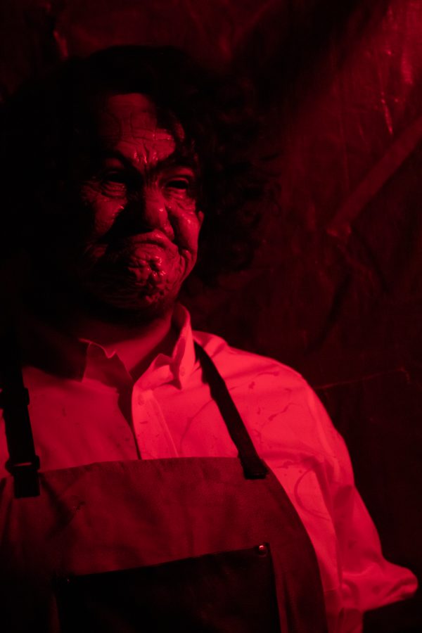 Bronson Torres poses as Leather Face from the “The Texas Chainsaw Massacre” franchise at the Theta Chi fraternity haunted house Oct. 22. Torres stated that his favorite part of the haunted house was “that we are back, this year specifically. It's been a historic event we do every year. I’m just excited to bring that fun back to campus.” (Grayson Reed | The Collegian)