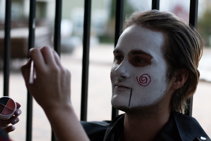 Tyler Johnson gets his face painted to play as the antagonist from the “Saw” movie at the Theta Chi fraternity haunted house Oct. 22. The haunted house took place at The Outpost Fort Collins leasing center at 530 Lupine Drive. The Colorado State University fraternity hosted the yearly haunted house to sponsor a fundraiser for the United Service Organizations. 100% of the proceedings went to the USO. (Grayson Reed | The Collegian)