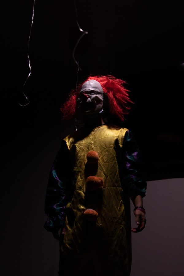 Justin Debusschere waiting for guests to enter the clown themed room at the Theta Chi fraternity haunted house at The Outpost Leasing Center at 530 Lupine Drive, Fort Collins Oct 22. The Colorado State University fraternity hosted the yearly haunted house to sponsor a fundraiser for the United Service Organizations as their roots were based from military students, 100% of the proceedings went to the USO. (Grayson Reed | The Collegian)