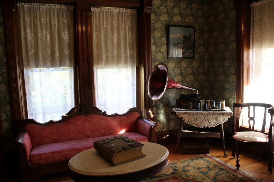 The front parlor of the 1879 Avery House, Oct. 23. Pictured to the right is a gramophone, a record player that was popular in the 1870s. The front parlor was most often used for business meetings, while the back parlor was used more for family gatherings. (Cat Blouch | The Collegian) 