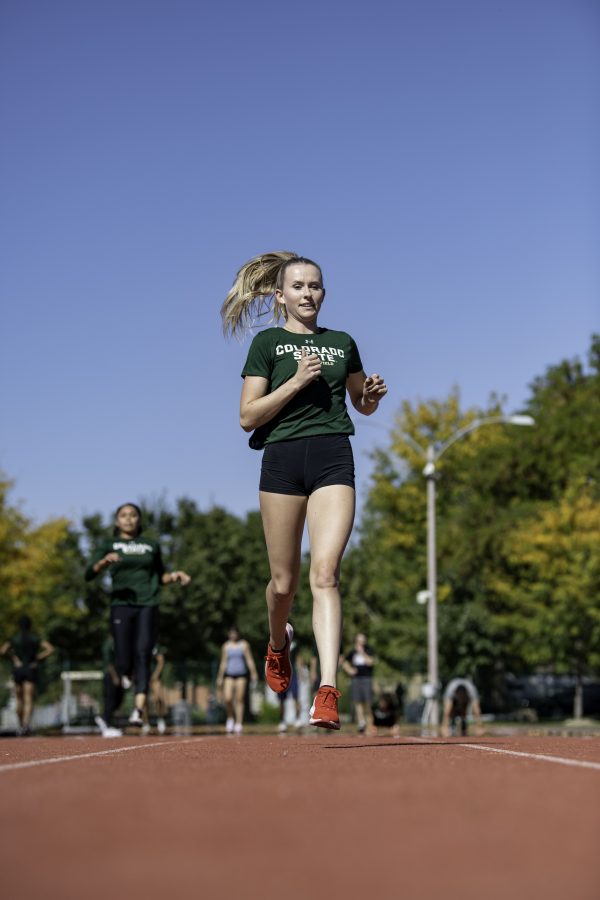 Lauren Gale warms up at practice with the Colorado State University track team on the Jack Christiansen Memorial Track Fort Collins Colorado. Gale after being away for the 2021 Tokyo Olympics stated, “I’ve missed Colorado and missed all my teammates and friend here so I’m excited to be back and run with the team.” Oct. 4. (Garrett Mogel | The Collegian)
