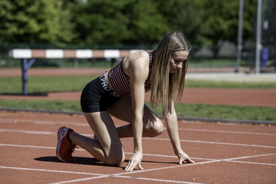 Lauren Gale in her 2021 Olympic jersey poses in a start position on the Jack Christiansen Memorial Track Fort Collins Colorado Oct. 4. (Garrett Mogel | The Collegian)