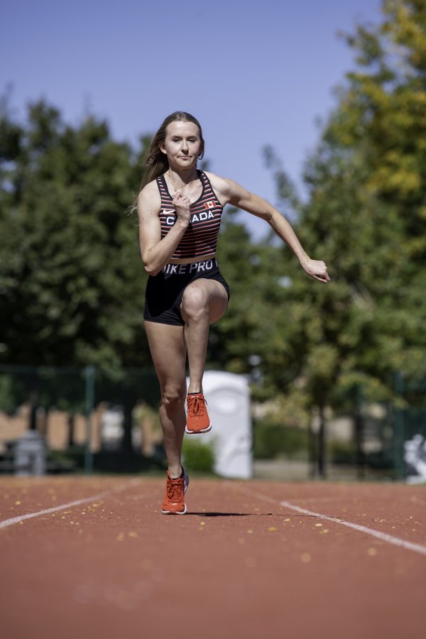Lauren Gale in her 2021 Olympic jersey runs toward the camera on the Jack Christiansen Memorial Track Fort Collins Colorado. Gale stated, “I’ve missed Colorado and missed all my teammates and friend here so I’m excited to be back and run with the team.” Oct. 4. (Garrett Mogel | The Collegian)
