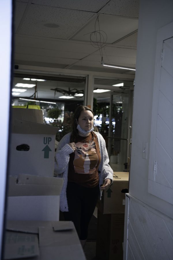 Kaley Smylie-Halligan co-owner of Horsetooth Stems and Roots House Plant Boutique in Fort Collins Colorado walks through the backroom to a truck carrying hand chosen plants from a Denver supplier Oct. 4. (Garrett Mogel | The Collegian)