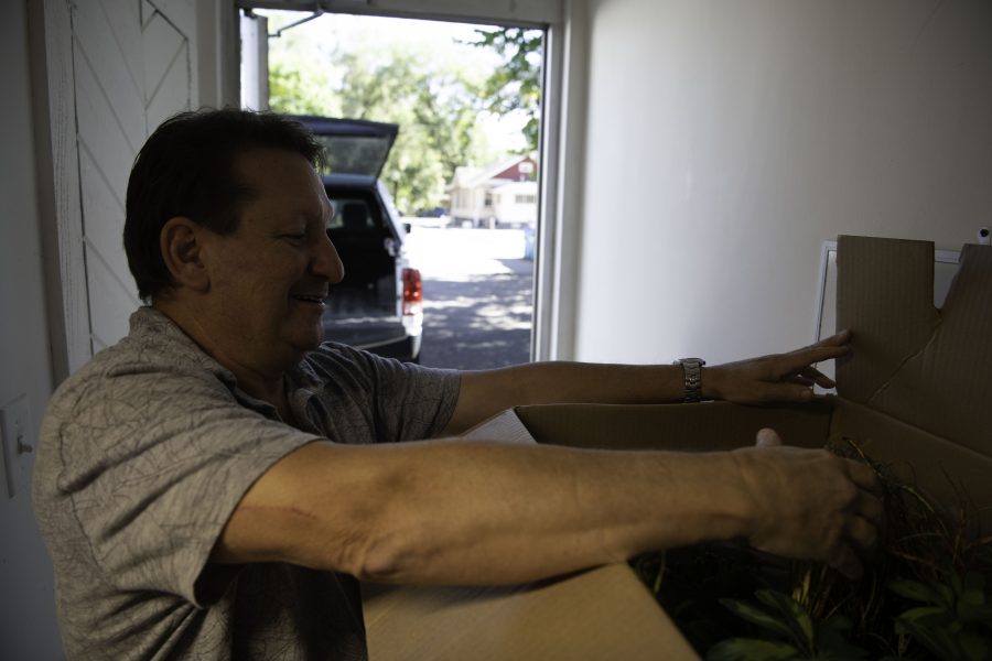 David Cantor co-owner of Horsetooth Stems and Roots House Plant Boutique in Fort Collins Colorado unboxes plants hand chosen from a Denver supplier Oct. 4. (Garrett Mogel | The Collegian)
