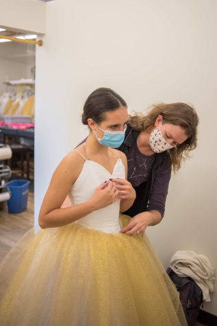 Elise Kulovany, shop manager at Colorado State University's Costume Shop, helps fit Madelyn Caviness' dance costume in the fitting room Oct. 24.