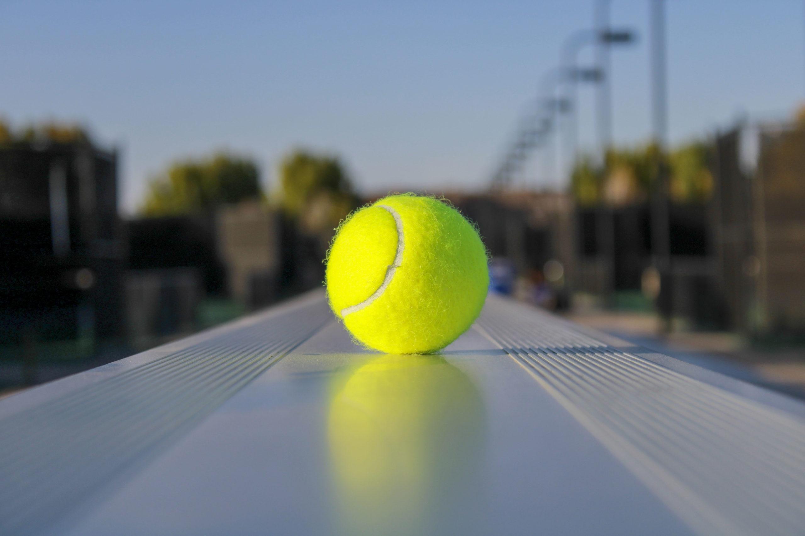 A tennis ball sits on bleachers