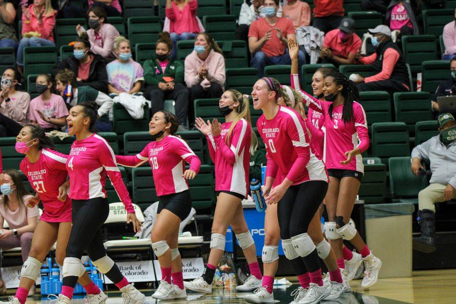 The Colorado State womens volleyball team cheers on their teammates as they score a point against the University of New Mexico. Photographer: Avery Coates