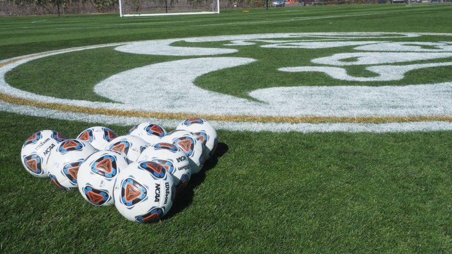 A triangle of soccer balls on the Colorado State University soccer field next to the Ram Field logo Oct. 15, 2021.