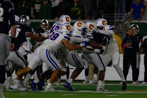 A host of Colorado State defenders tackle Nevada wide receiver Romeo Doubs (7) Nov. 27.