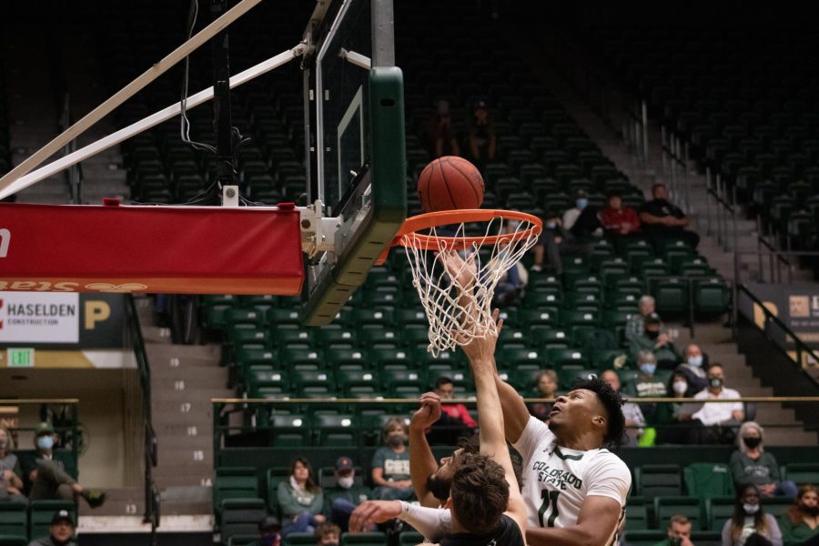 Colorado State forward Dischon Thomas goes to retrieve the ball after a failed lay-up by Adams State player on Oct. 31. CSU won the game against Adams State 92-55.  (Mykyta Prykhodko | The Collegian)