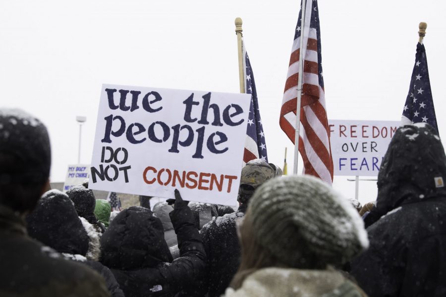 An attendee of a rally against vaccine mandates holds up a sing outside the Larimer County Health Department, 1525 Blue Spruce Drive Fort Collins Colorado Nov. 1. (Garrett Mogel | The Collegian)
