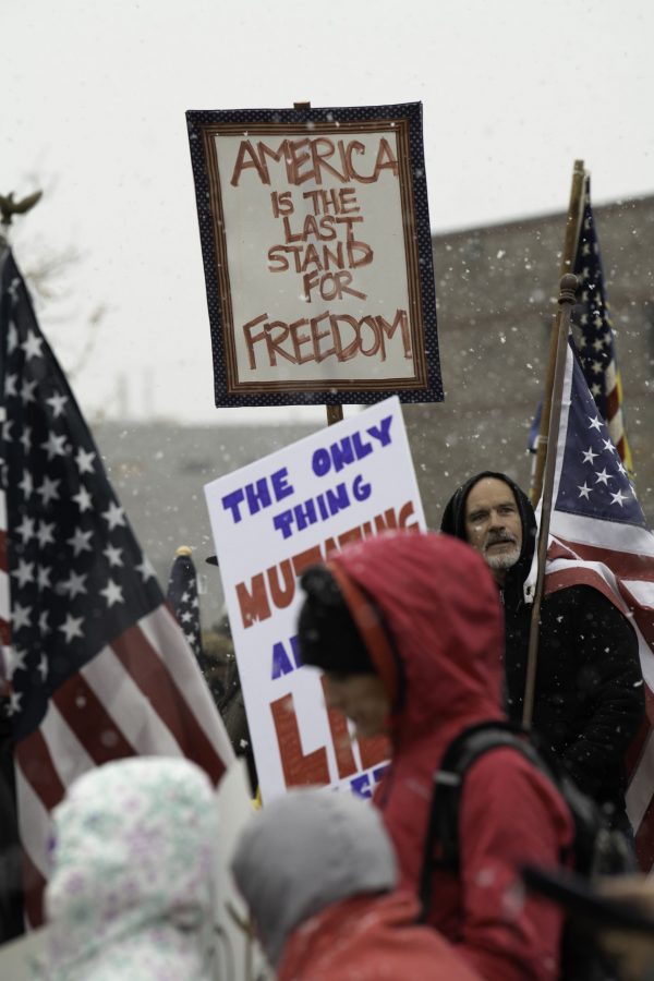 A group of rally-goers gather outside the Fort Collins Colorado Public Health Building Nov. 1. Individuals voiced concerns about varying topics including personal freedoms, vaccine mandates, and health policies. (Garrett Mogel | The Collegian)
