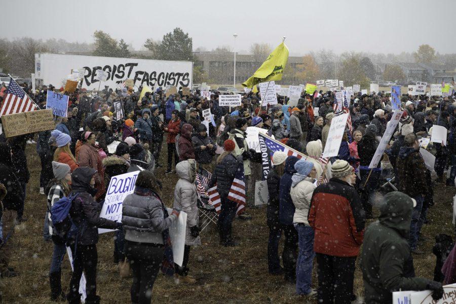 A group of rally-goers gather outside the Fort Collins Colorado Public Health Building Nov. 1. Individuals voiced concerns about varying topics including personal freedoms, vaccine mandates, and health policies. (Garrett Mogel | The Collegian)