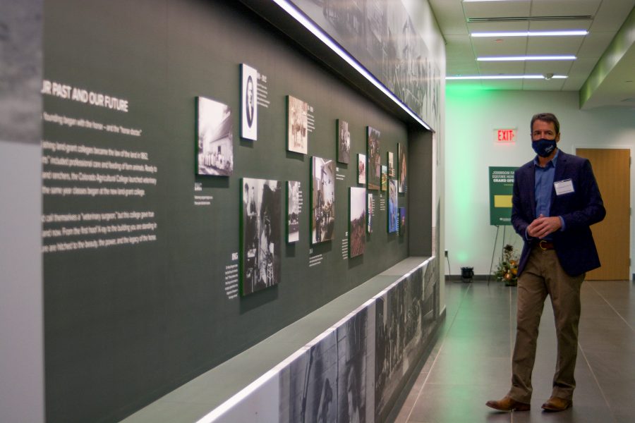 Dr. Christopher Kawcak, director of clinical services at Johnson Family Equine Hospital shows off the history wall