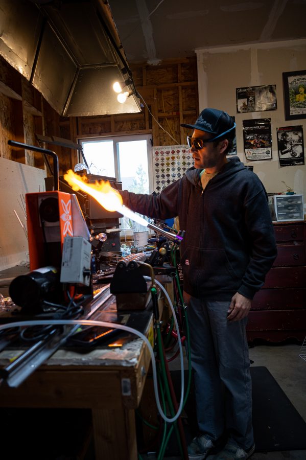 Bryan Ratcliffe works on his mountain themed glass work