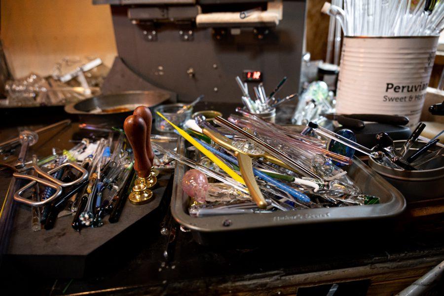 Some of the many tools and glass colors at Bryan Ratcliffe's home studio Nov. 2. Ratcliffe talked about material shortages and price fluctuations and stated, "Certain things have stopped being made and stuff has tripled in price because of shipping container prices" (Milo Gladstein | The Collegian)
