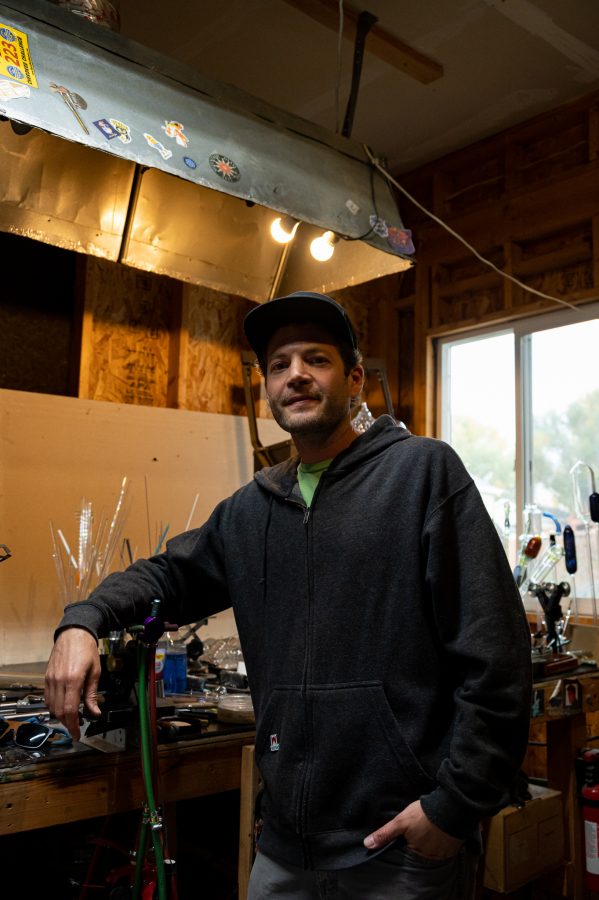 Bryan Ratcliffe stands in his shop he built in his garage Nov. 2. Ratcliffe has been glassblowing for 20 years and stated, "I like the fact that I don't nessicarily have to be tied to a store or retail outlet." (Milo Gladstein | The Collegian)