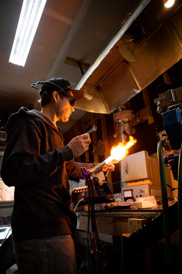 Bryan Ratcliffe uses a shaping tool on one of his new mountain inspired drinking glasses