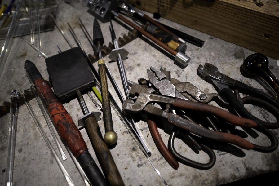 Tools and pieces of glass sit on a worktable inside Kind Creation Fort Collins Colorado Nov. 3. (Garrett Mogel | The Collegian)
