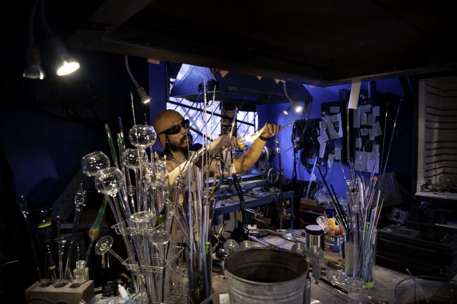 En-tao Andrew Hsu, artist name Torch Mouth tests a newly fabricated chest rig at Kind Creation Fort Collins Colorado Nov. 3. Torch Mouth stated "I'm half-assed good at a bunch of shit and wondered like what positioning I could get myself into." (Garrett Mogel | The Collegian)