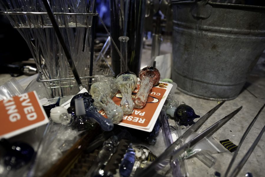 Three pipes lay among tools and pieces of glass inside Kind Creation Fort Collins Colorado Nov. 3. (Garrett Mogel | The Collegian)