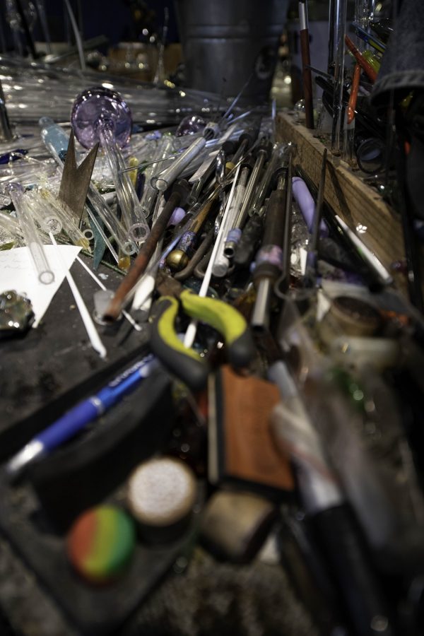 Tools and pieces of glass sit on a worktable inside Kind Creation Fort Collins Colorado Nov. 3. (Garrett Mogel | The Collegian)