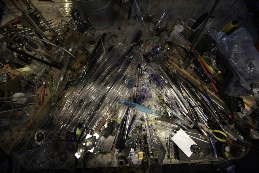 Tools and pieces of glass sit on a worktable inside Kind Creation Fort Collins Colorado Nov. 3. (Garrett Mogel | The Collegian)