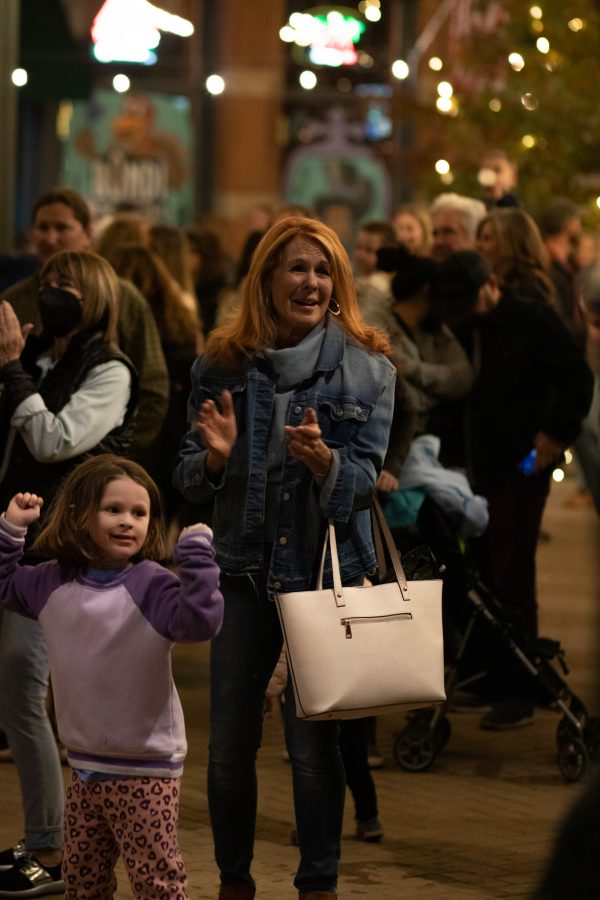 Bystanders enjoying the light show at the Fort Collins, Old Town Square lighting ceremony Nov 5. The ceremony hosted the live jazz band Atom Collective. (Grayson Reed | The Collegian)