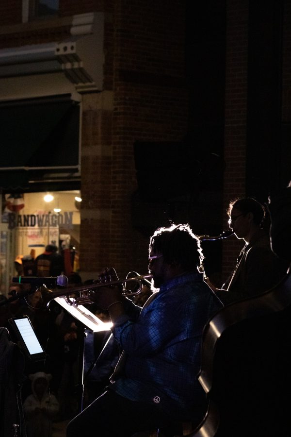 Adisa Nickerson playing trumpet for the live jazz band Atom Collective at the Fort Collins, Old Town Square lighting ceremony Nov 5. (Grayson Reed | The Collegian)