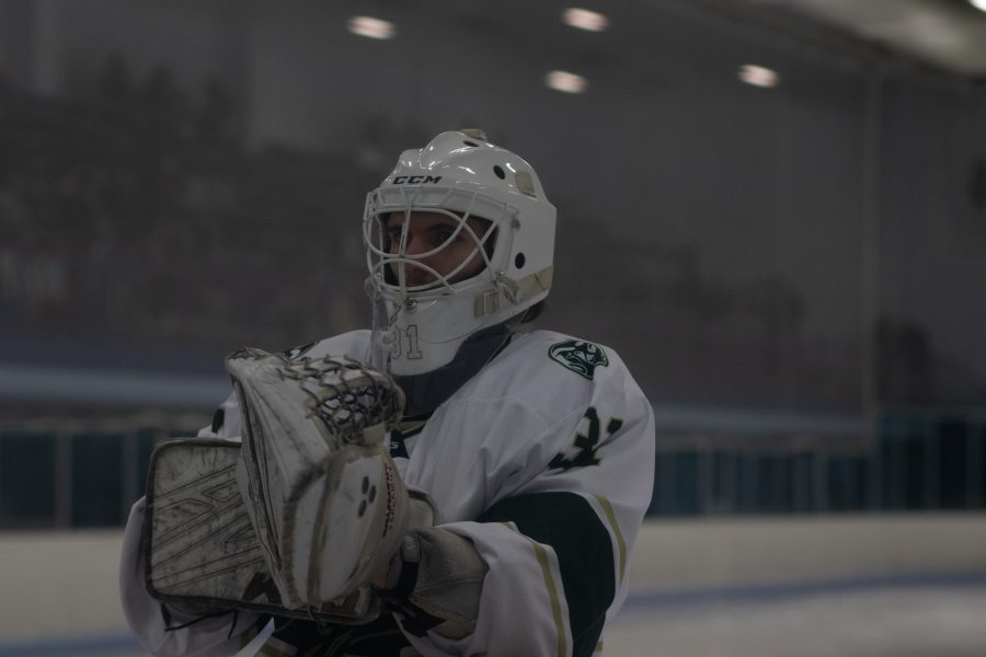 Sam Simon (31) of Colorado State University prepares his gloves for the second period Nov 6. The game ended with University of Colorado winning 8-4 over CSU. (Grayson Reed | The Collegian)
