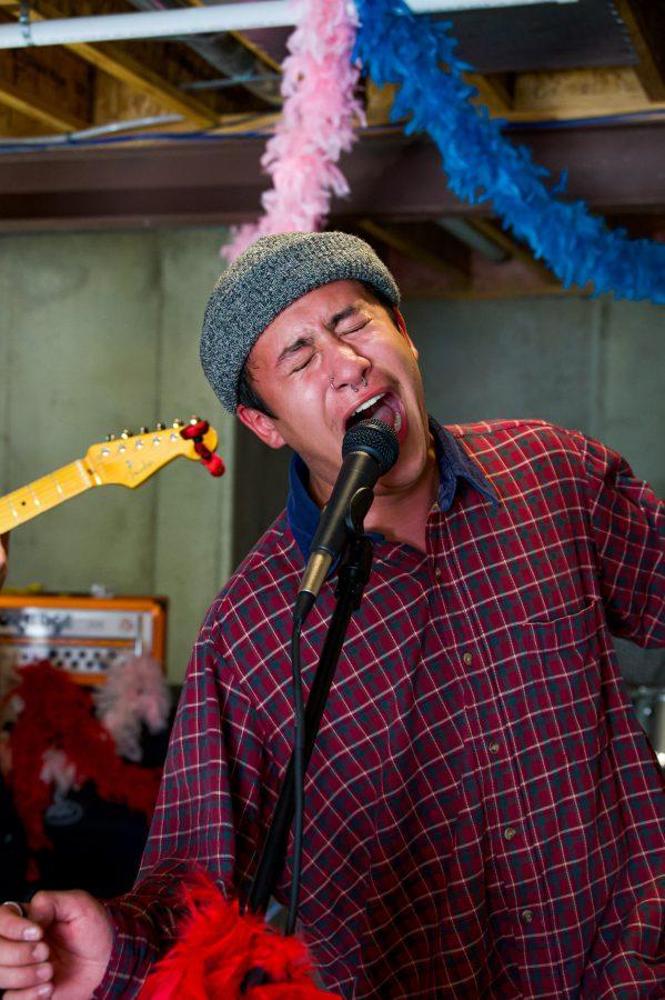 Violet Visionaries band member Austin Dougherty sings in his garage during band practice Nov. 7. (Milo Gladstein | The Collegian
