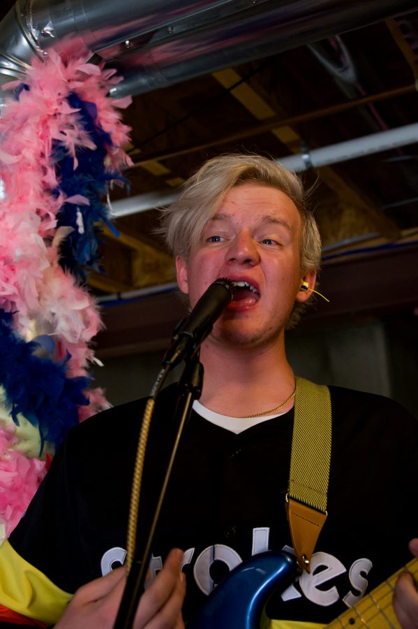 Violet Visionaries band member Jayden Yackey sings along to "Camper Story" during practice Nov. 7. (Milo Gladstein | The Collegian)