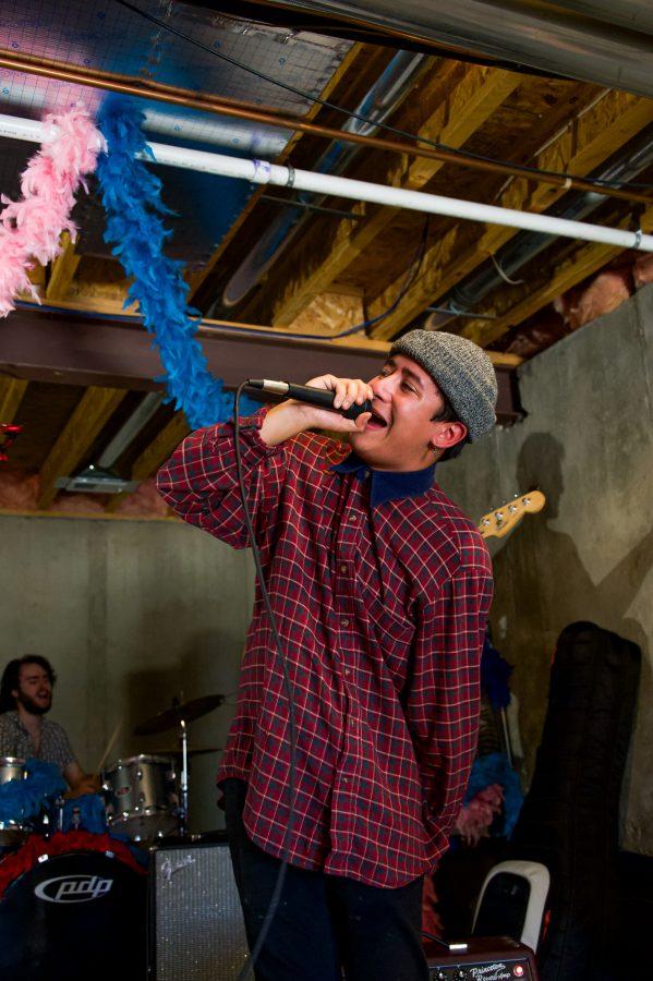 Violet Visionaries band member Austin Dougherty sings during band practice Nov. 7. (Milo Gladstein | The Collegian)