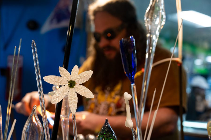 Sky Norton works amid some of the newest works in progress in the Kind Creations shop Nov. 9. (Milo Gladstein | The Collegian)