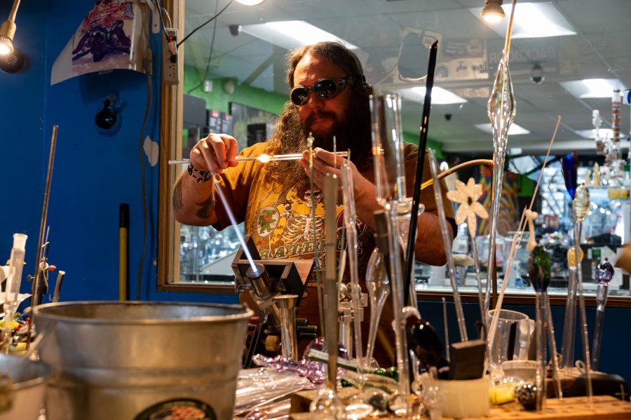 Skye Norton blows a new piece in Kind Creations Nov. 9. Norton buys sticks of color from $50 to $250 per pound. (Milo Gladstein | The Collegian)