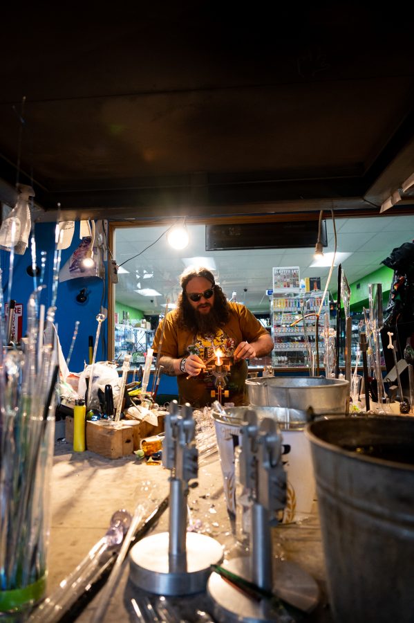 Skye Norton works in the Kind Creations shop Nov. 9. Norton stated that Kind Creations "is the first smoke shop to have a glass blowing studio in all of Colorado." (Milo Gladstein | The Collegian)