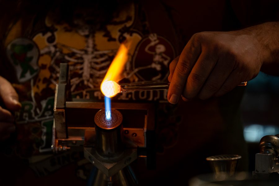 Skye Norton works with the torch in the studio at Kind Creations Nov. 9. Norton grew up watching metal workers making small figurines in Ohio. (Milo Gladstein | The Collegian)